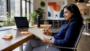 Business owner sketching website sitemap at desk