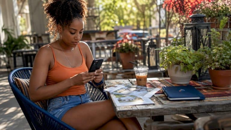 Woman browsing real estate on smartphone at home