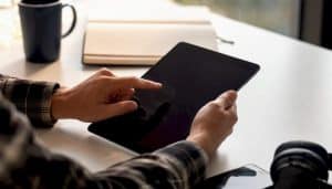 Hands adjusting digital marketing dashboard on tablet