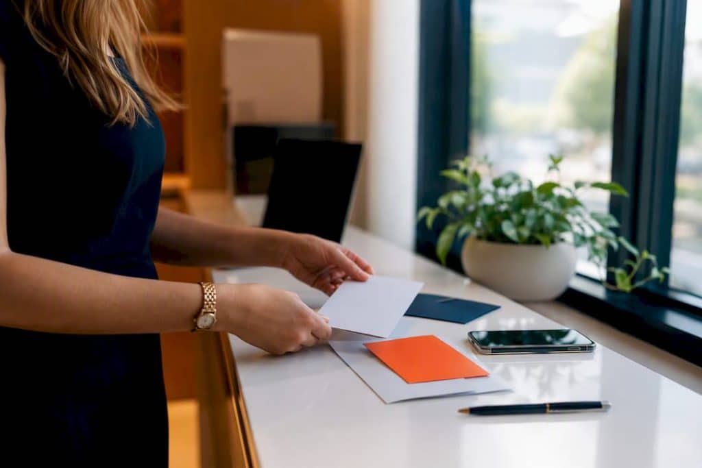 Hands arranging email marketing materials