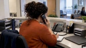 Clinic coordinator handling appointment booking call